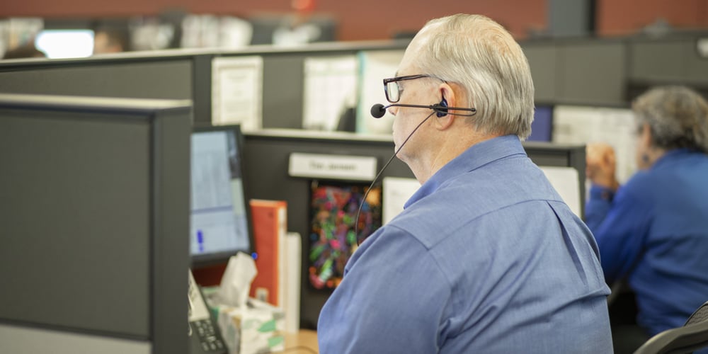 Man using headset for phone call at desk